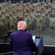 Trump and U.S. soldiers in the background