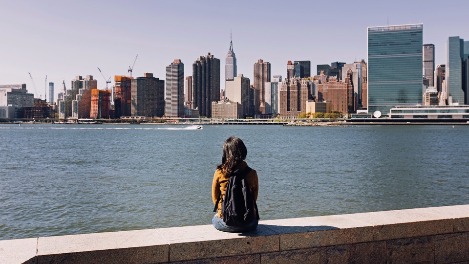 A young woman gazes at Manhattan's skyline
