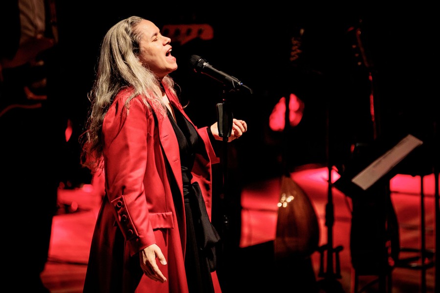 A performer sings on a stage.