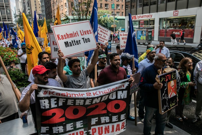 Protesters in New York City hold up banners and placards criticizing the Indian government.