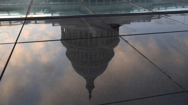 U.S. Capitol building reflected in a puddle