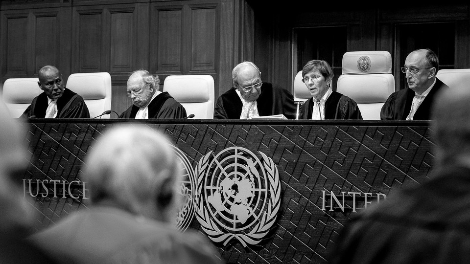A black-and-white photograph of the judicial bench in the International Court of Justice