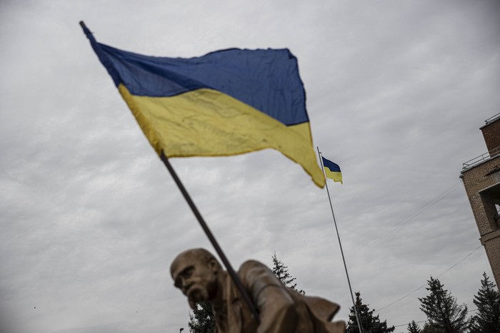 Ukrainian flag waving in front of a cloudy sky