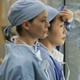 Meredith Grey and Cristina Yang look through a hospital window