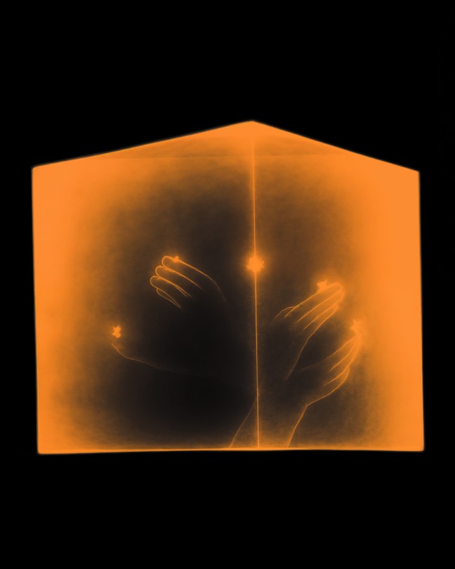 A drawing of four hands inside an orange-hued prism shaped like a house, with a line of light through the center