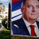 People walk by a Dodik campaign billboard in Banja Luka in September.