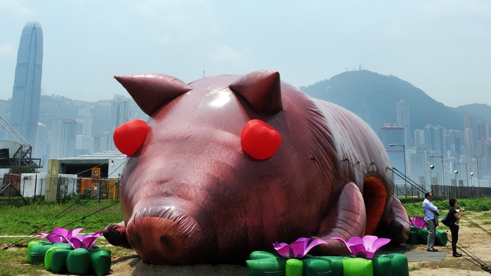 A giant sculpture of a pig with red eyes 
