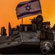 Israeli soldiers on a tank near the Israel-Gaza border