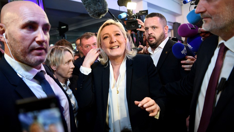 Far-right leader Marine Le Pen surrounded by people