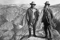 Theodore Roosevelt stands with John Muir on Glacier Point in Yosemite.