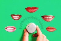 A hand turning a dial in the direction of different mouths