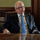 A color photograph of Tim Walz seated in his office