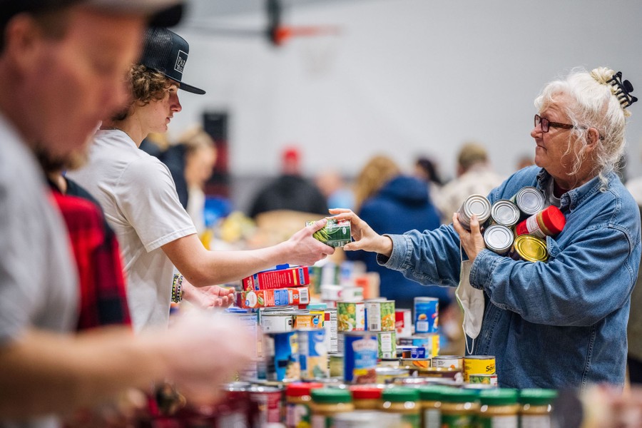 A woman receives food at a distribution center.