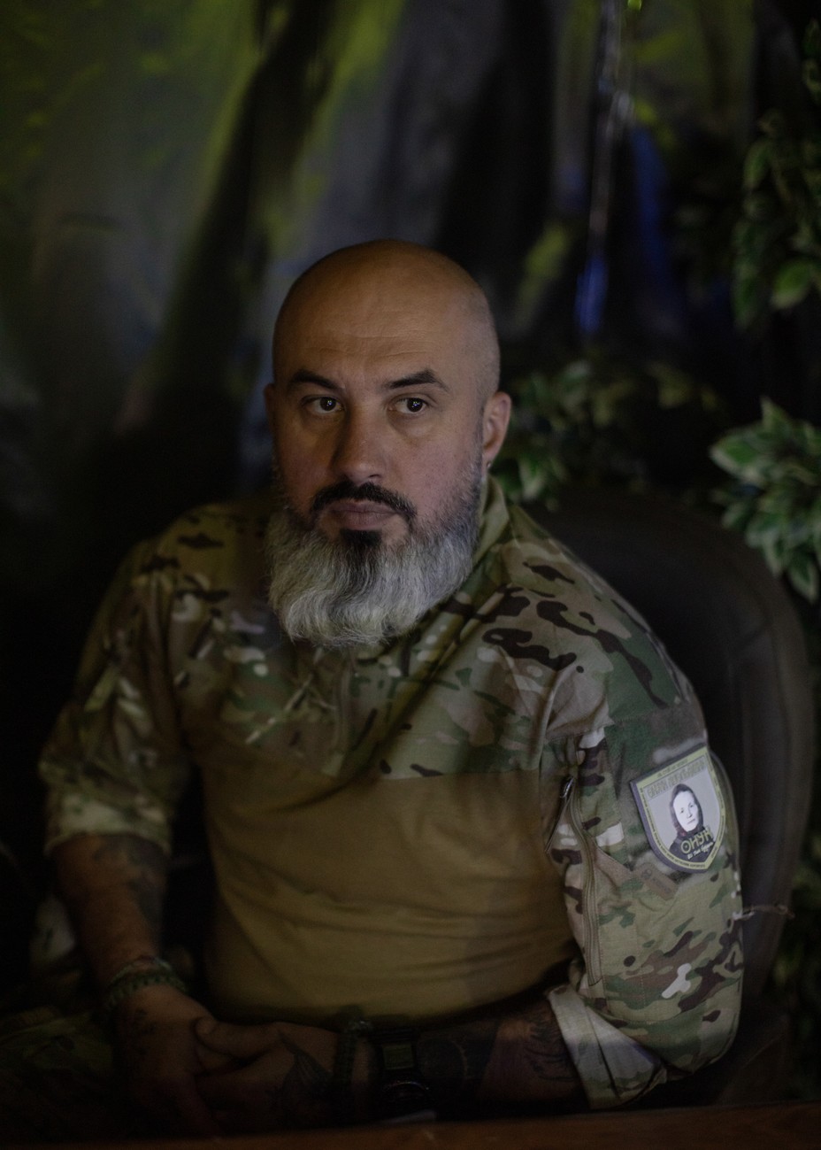 A bald man with a gray beard wearing a military uniform.