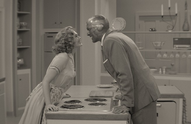 Wanda and Vision smiling at each other over a stove in 'WandaVision'
