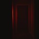 Front view of a door illuminated with red lighting in dark corridor.