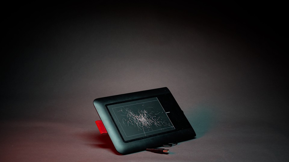 A photo illustration of a designer's cracked Wacom pen tablet