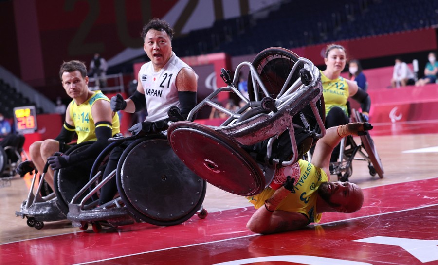 A player falls among others during a wheelchair rugby match.