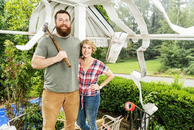 Ben and Erin Napier pose in front of a wall-under-construction in "Home Town"