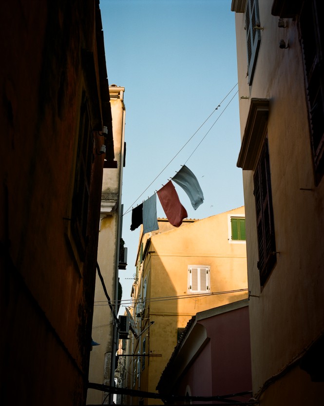 Picture of laundry hanging to dry high above the streets of Corfu Old Town