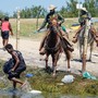 DHS agents with Haitian migrants at the border
