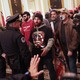 Insurrectionists inside the Capitol building, confronted by police. Man in center is wearing a QAnon T-shirt.