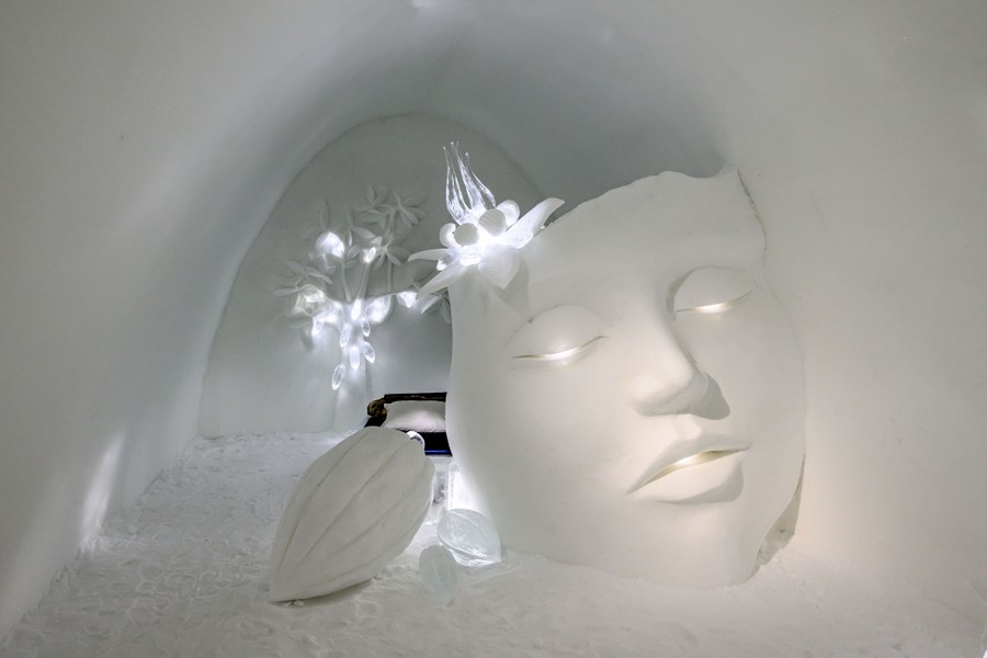 Một căn phòng được chạm khắc bằng tuyết gần như được lấp đầy bởi tác phẩm điêu khắc khuôn mặt một người bằng tuyết và một số đồ trang trí.