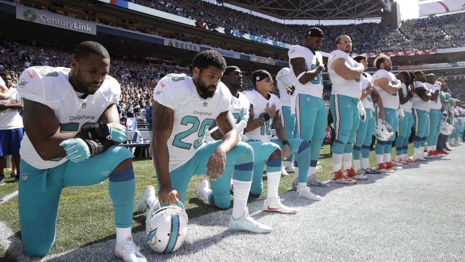 Miami Dolphins players knelt during the playing of the national anthem Sunday