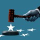 From a deep cerulean background a hand emerges with just the sleeve of a suit jacket visible. The hand is holding a red gavel. Below the gavel a white star is upright. To the right and left other white stars have fallen flat and are fractured.