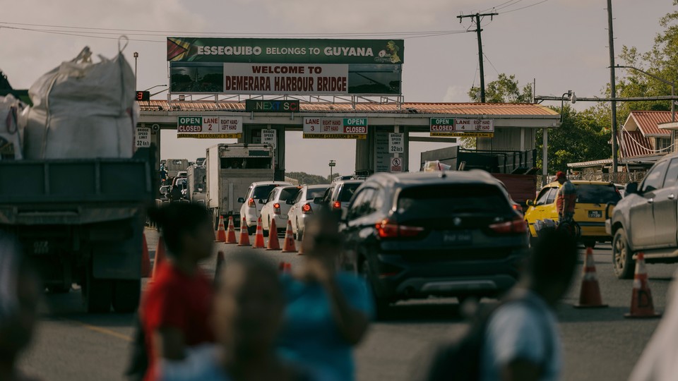 As commuters navigate through the Mandela/Eccles Roundabout, a sign that reads ESSEQUIBO BELONGS TO GUYANA greets commuters on the newly created portion of highway on the East Bank Demerara River, Georgetown, Guyana, on Thursday, Jan. 25, 2024.