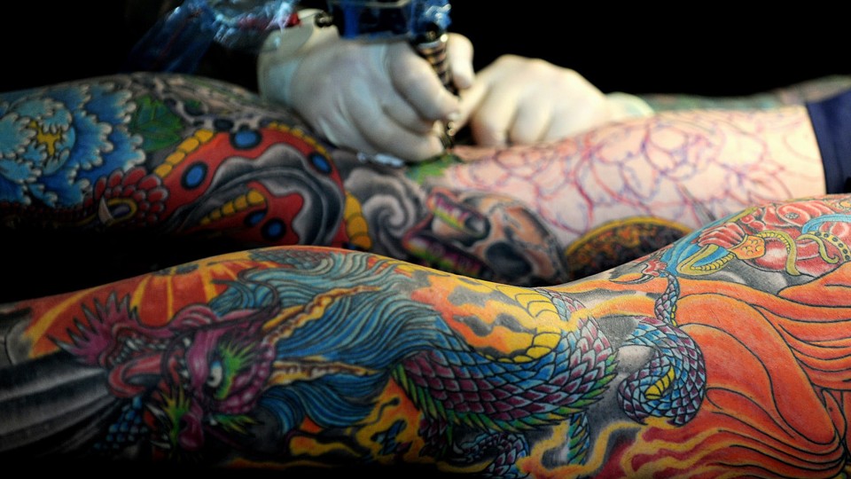 An image of tattooed legs