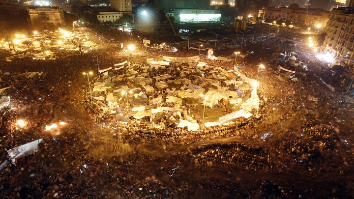 Anti-government protesters celebrate inside Tahrir Square after the announcement of Egyptian President Hosni Mubarak's resignation in Cairo February 11, 2011.