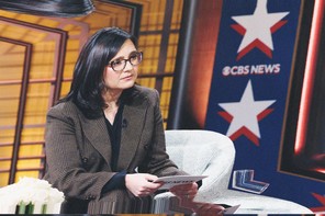 A subtly warped color photograph of Bari Weiss giving an interview with the CBS News logo in the background.