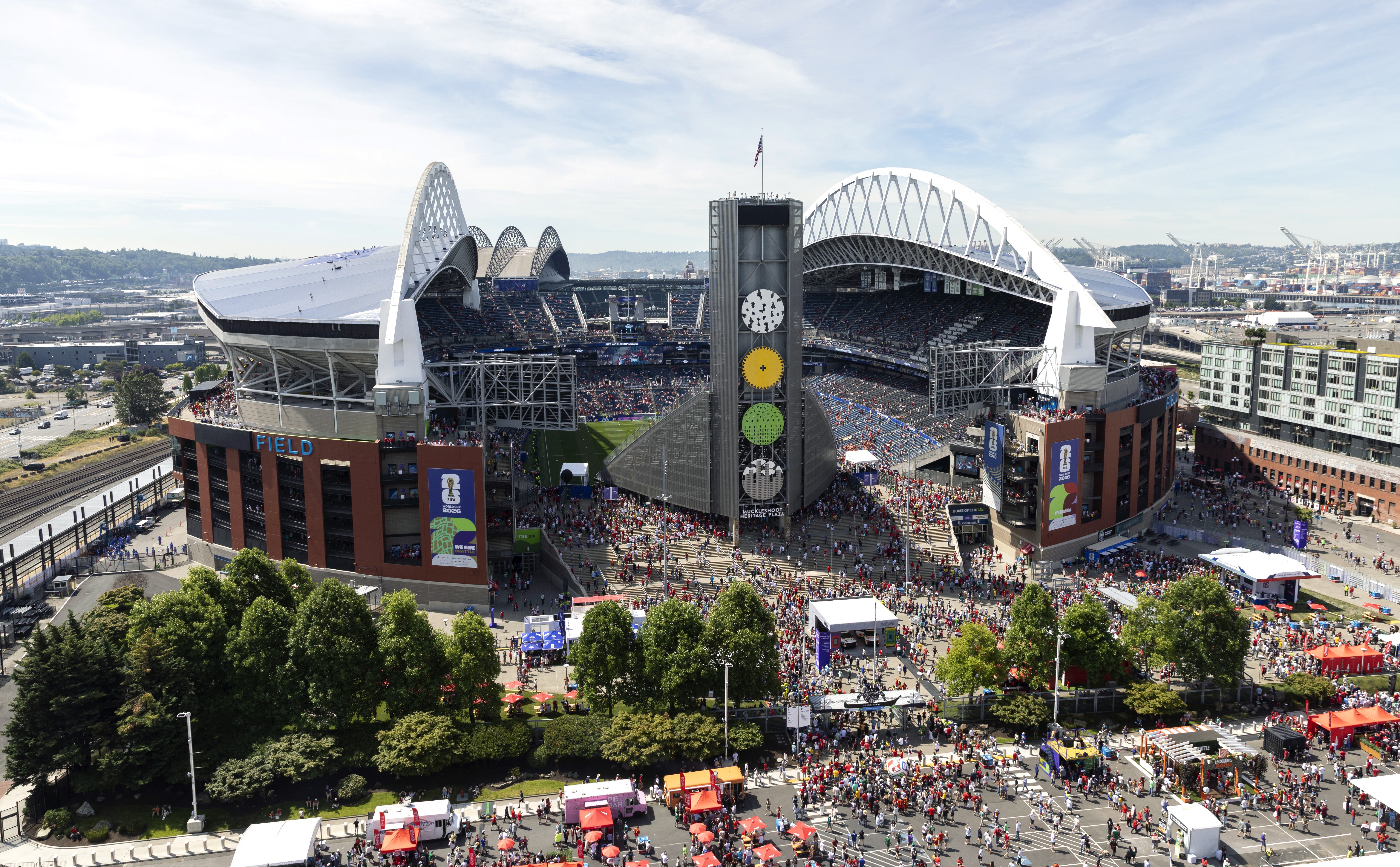 An elevated view of fans entering a large sports stadium in Seattle.