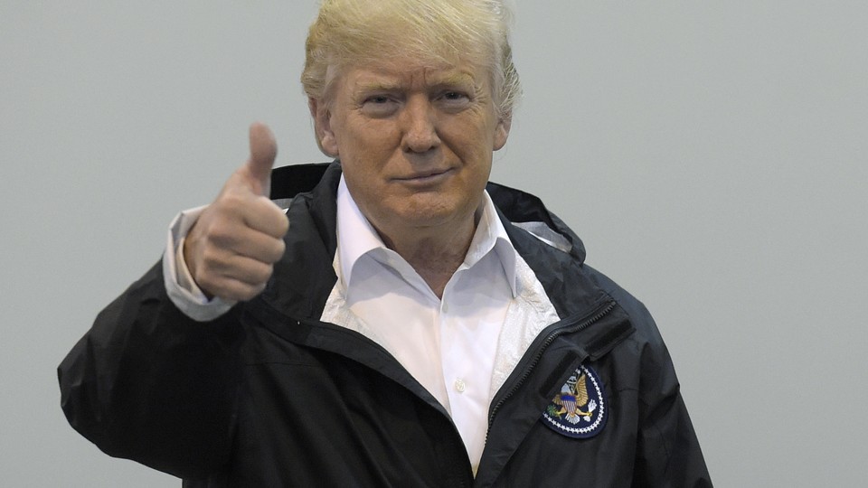 Donald Trump gestures a thumbs up.