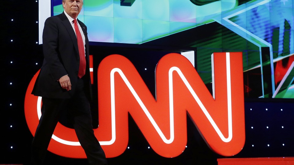 Donald Trump in front of the CNN logo