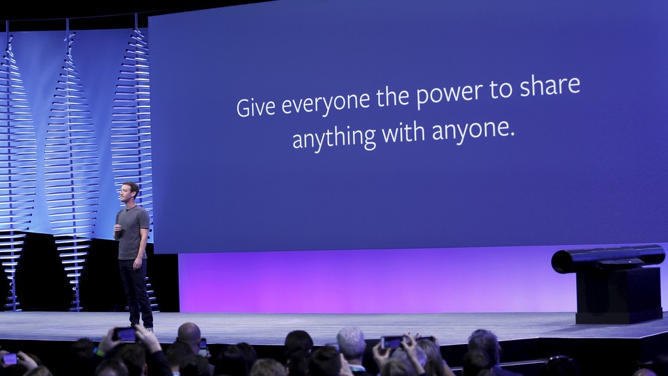 Mark Zuckerberg stands in front of a slide that says “Give everyone the power to share anything with anyone.”