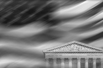 An image of the Supreme Court building against the backdrop of a blurred American flag.