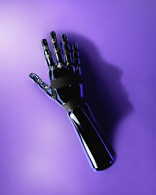 A robotic hand casting a shadow shaped like a human head.