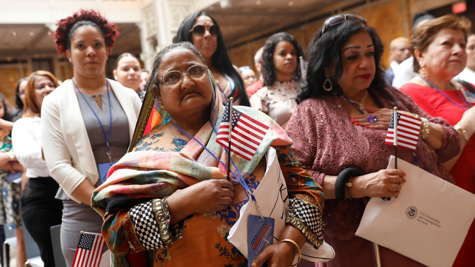 immigrants swearing in at naturalization ceremony