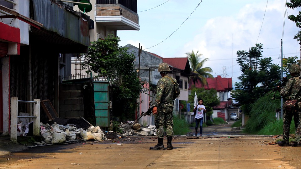 Government soldiers patrol Sarimanok village in Marawi City, which has been overrun by members of the Maute Islamist militant group, on June 1, 2017.