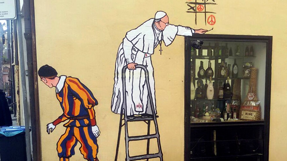 A graffiti depicting Pope Francis and a Swiss guard in Borgo Pio, in Rome.
