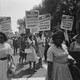 A black and white photo featuring African Americans holding signs that read "We demand equal rights now!" "We march for integrated schools now!" and "We demand decent housing now!"