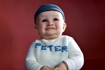 A baby with a shirt that says Peter