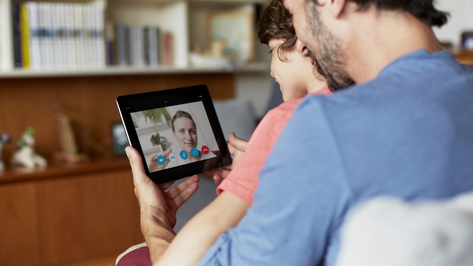 A father and son chat use Skype to video chat