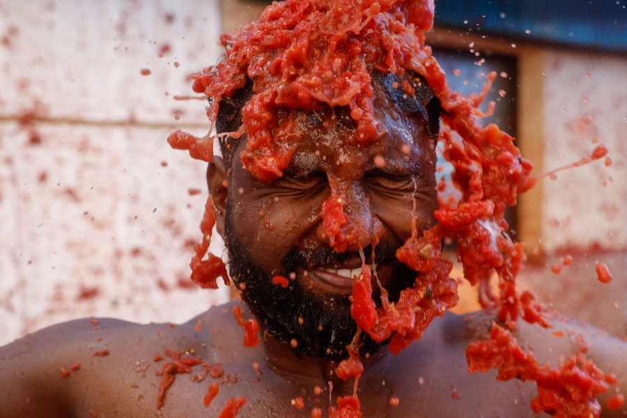 A person has smashed tomatoes dumped on their head.