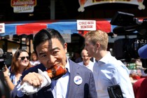 Andrew Yang enjoying a turkey leg at the Iowa State Fair