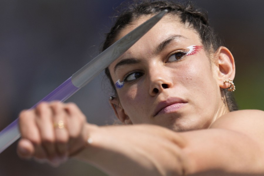 A close view of a person preparing to throw a javelin.