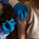 Woman getting a vaccine in her arm