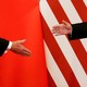 President Donald Trump and China's President Xi Jinping shake hands in Beijing.